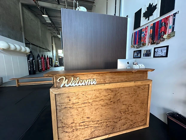 Handcrafted welcome desk at the entrance of the Mission BJJ academy